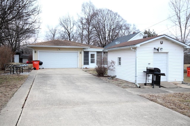 single story home featuring a garage and an outdoor structure