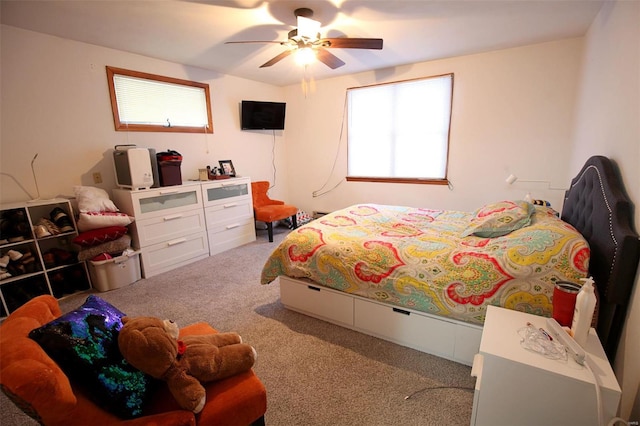 carpeted bedroom featuring ceiling fan and multiple windows