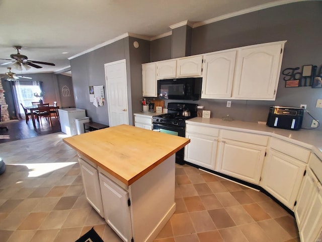 kitchen with white cabinetry, crown molding, black appliances, and a center island