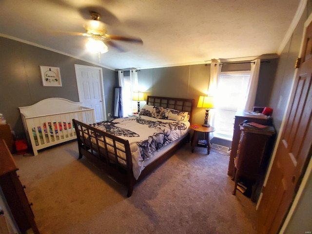 carpeted bedroom with ceiling fan, lofted ceiling, and ornamental molding