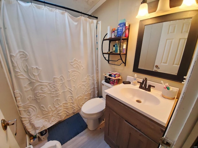 bathroom with toilet, walk in shower, wood-type flooring, and vanity