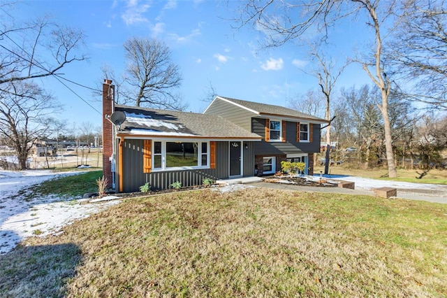 tri-level home with a front lawn, board and batten siding, and a chimney