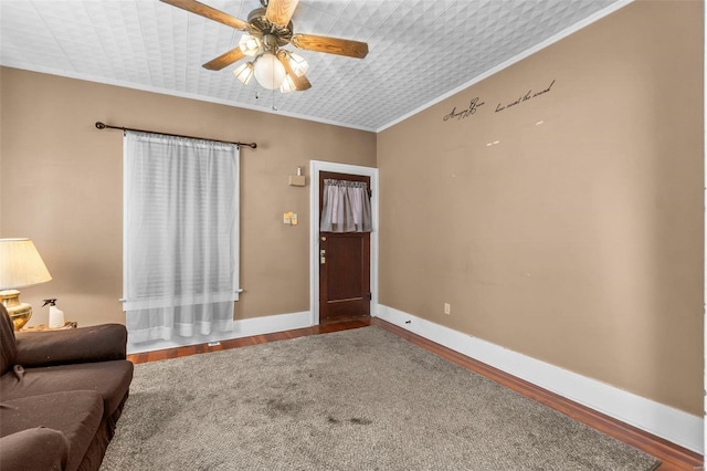 foyer entrance featuring ceiling fan, crown molding, and hardwood / wood-style floors