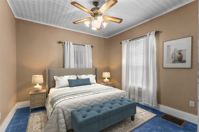 bedroom featuring ceiling fan, ornamental molding, and carpet floors