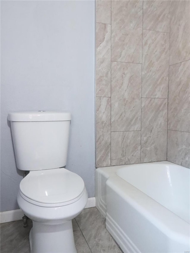 bathroom with toilet and tile patterned flooring