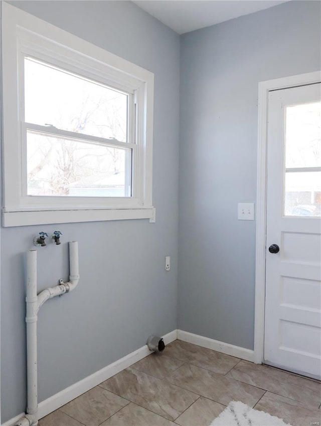 laundry area with washer hookup and light tile patterned flooring