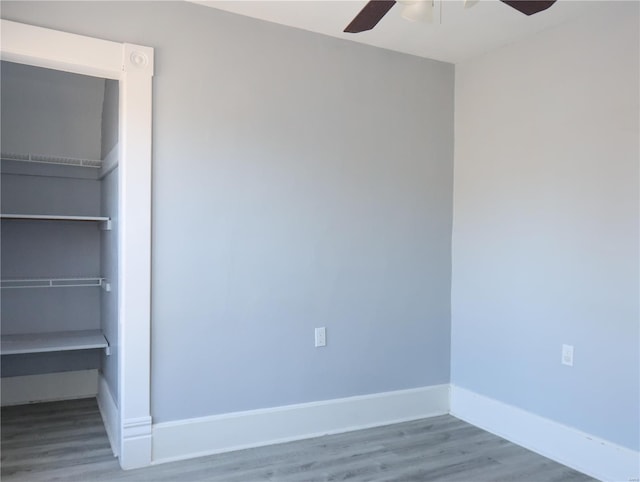 unfurnished room with ceiling fan and wood-type flooring