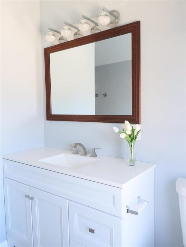 bathroom featuring toilet and vanity