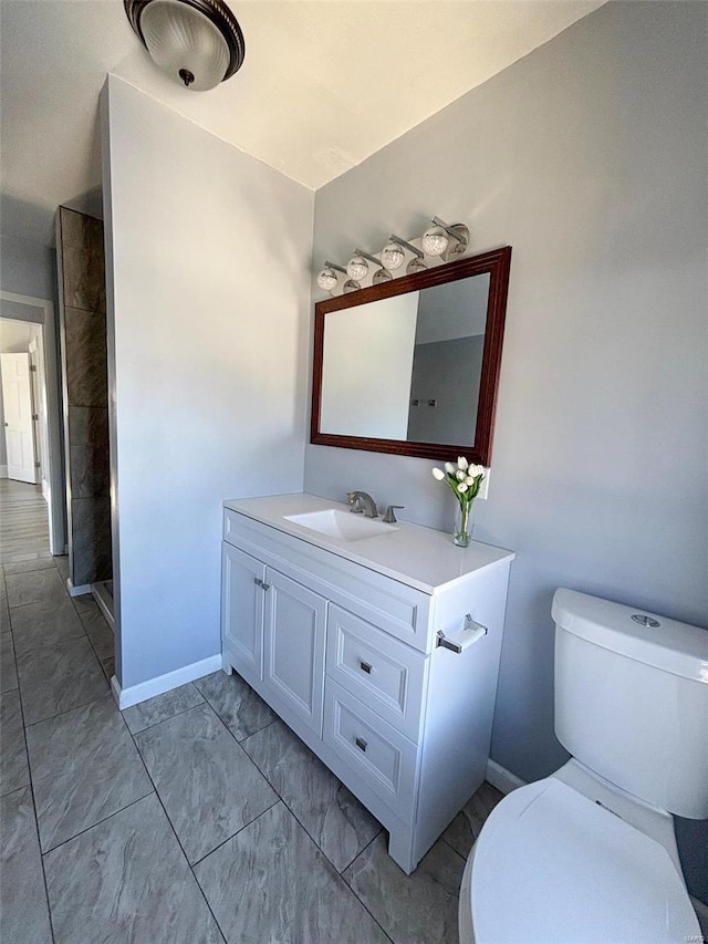 bathroom featuring toilet and vanity