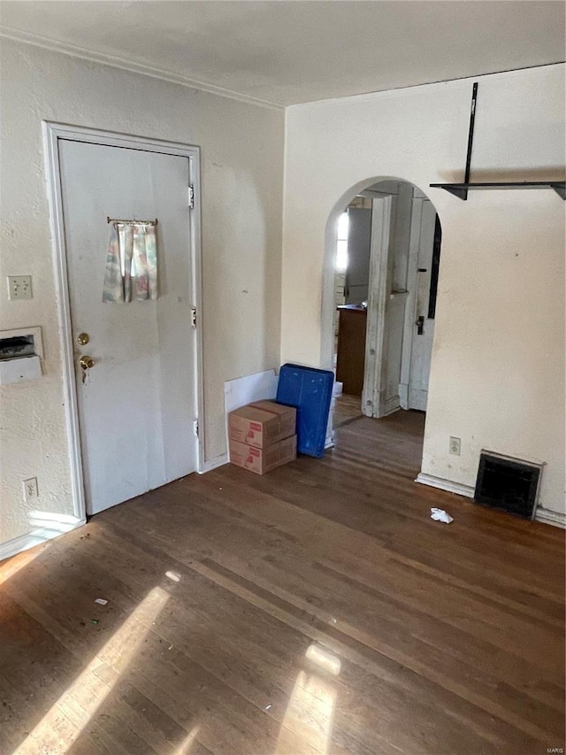 entrance foyer featuring ornamental molding and dark wood-type flooring