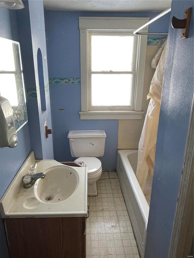 full bathroom with vanity, toilet, and shower / bath combo with shower curtain