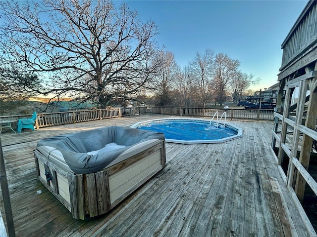 pool at dusk with a wooden deck