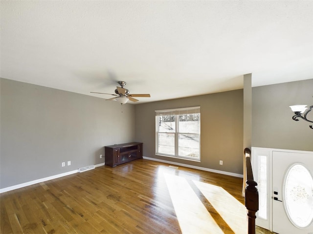 unfurnished living room featuring hardwood / wood-style floors and ceiling fan