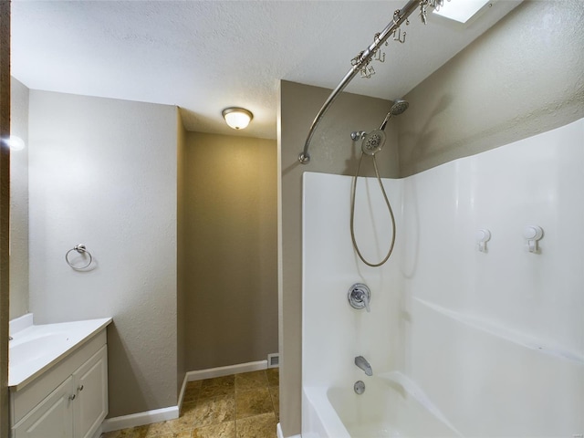 bathroom with vanity, a textured ceiling, and shower / bathing tub combination