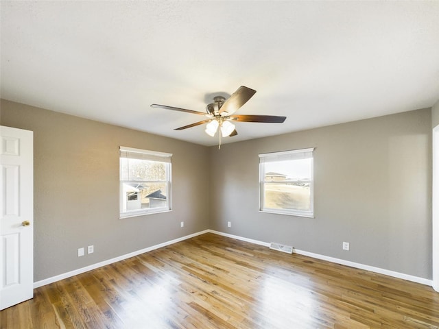 spare room with wood-type flooring and ceiling fan