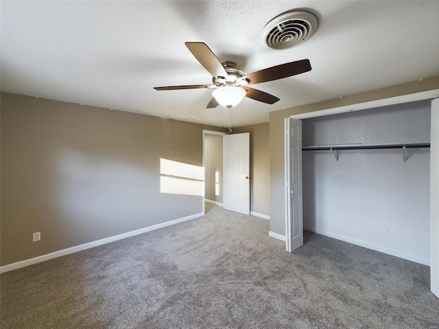 unfurnished bedroom with carpet flooring, ceiling fan, and a closet