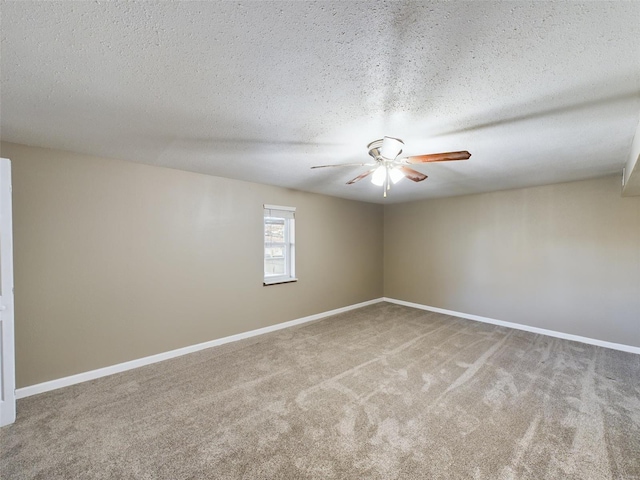 carpeted spare room with ceiling fan and a textured ceiling