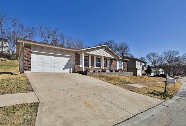 view of front of home featuring a garage, covered porch, brick siding, and driveway