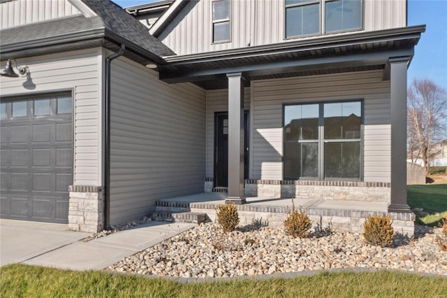 doorway to property featuring a porch and a garage