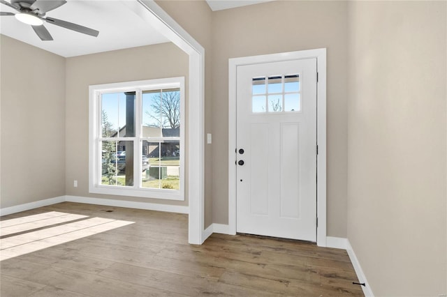 foyer with ceiling fan and wood-type flooring