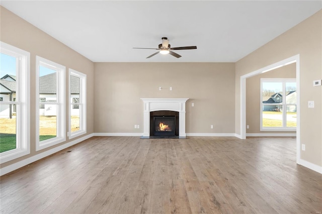 unfurnished living room featuring ceiling fan and light wood-type flooring