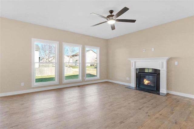 unfurnished living room with ceiling fan and light hardwood / wood-style floors