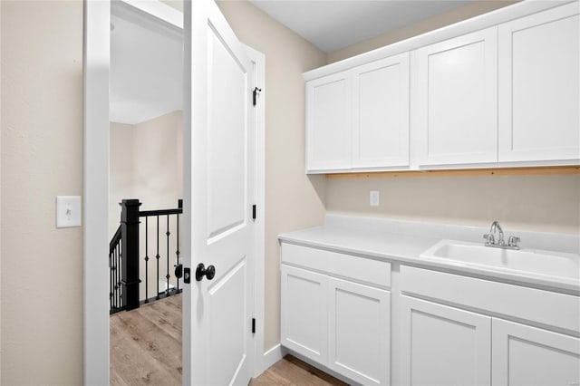 washroom featuring light wood-type flooring and sink