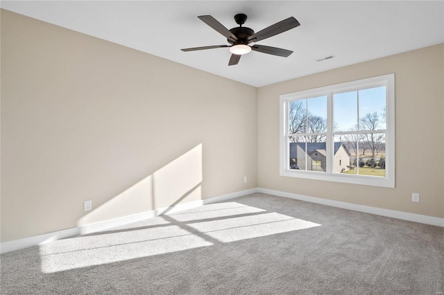 empty room with ceiling fan and light colored carpet