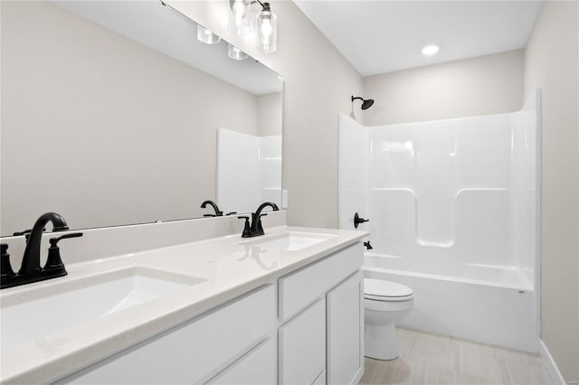 full bathroom featuring toilet, vanity, and shower / bathtub combination