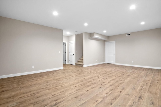 basement with light hardwood / wood-style flooring