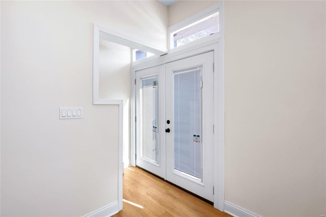 entryway featuring french doors and light wood-type flooring