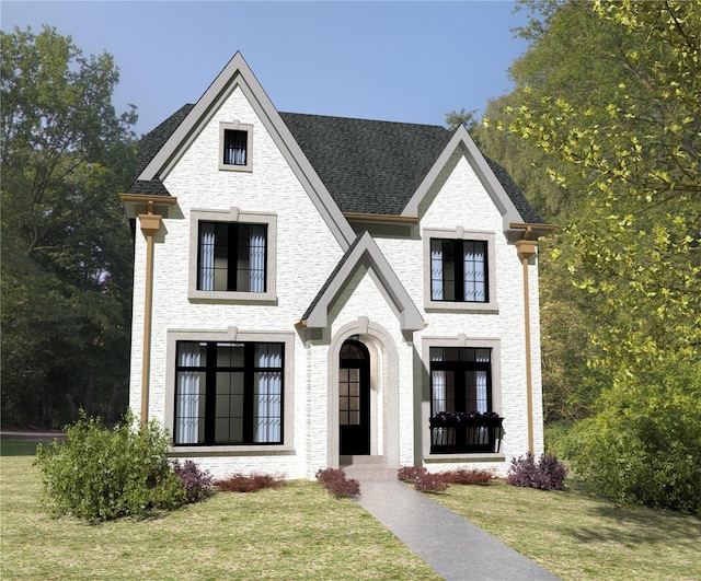 view of front facade featuring a front yard, brick siding, and roof with shingles