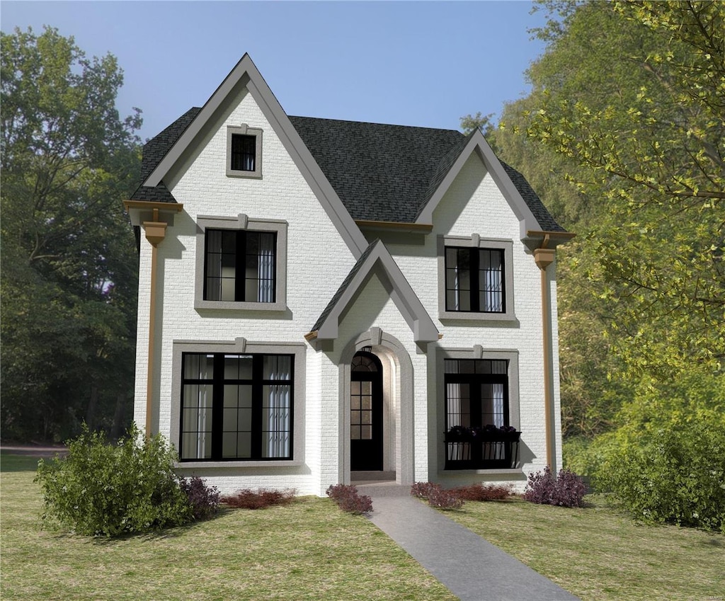 view of front of property with brick siding and a front yard