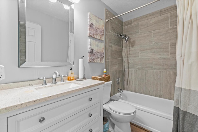 full bathroom featuring toilet, a textured ceiling, shower / bath combination with curtain, and vanity