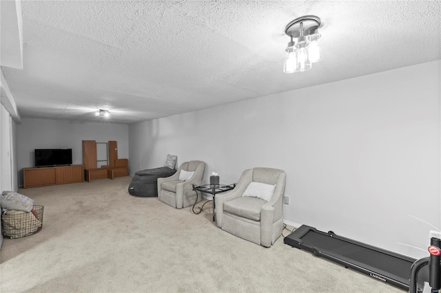 sitting room featuring a textured ceiling and light colored carpet