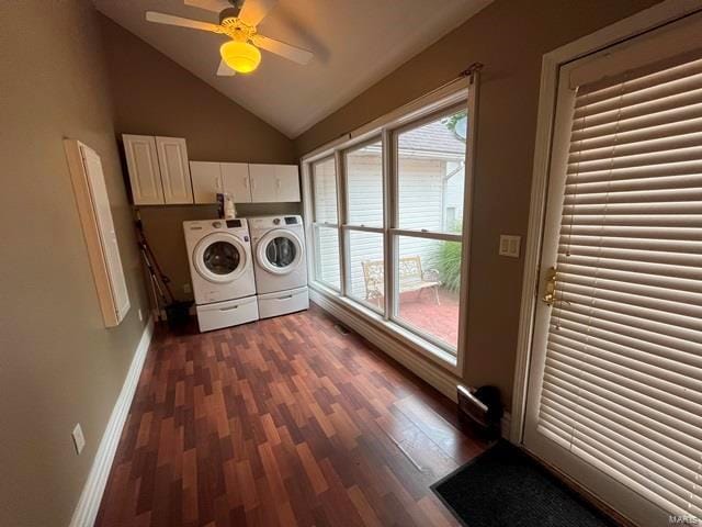 clothes washing area featuring cabinets, washing machine and clothes dryer, dark hardwood / wood-style floors, and a wealth of natural light