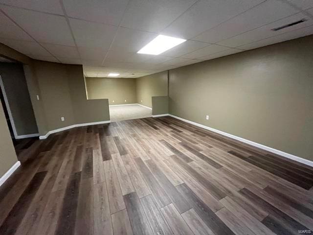 basement with hardwood / wood-style floors and a drop ceiling