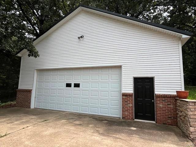 view of property exterior with an outbuilding and a garage