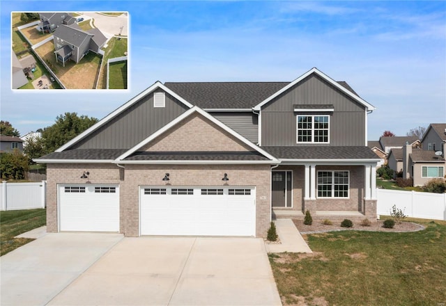 craftsman house featuring a garage and a front lawn