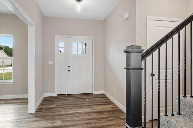 entryway with dark hardwood / wood-style flooring