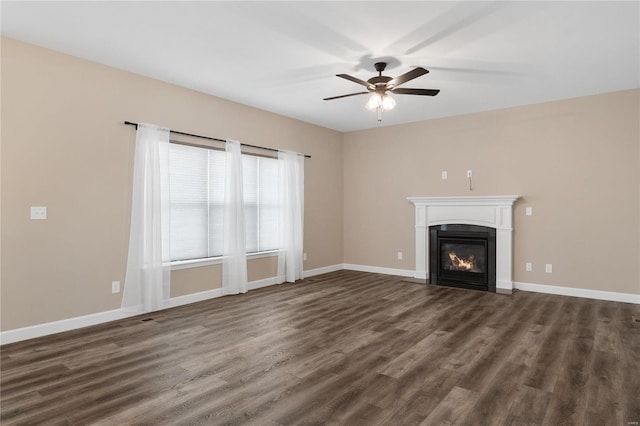 unfurnished living room featuring ceiling fan and dark hardwood / wood-style floors