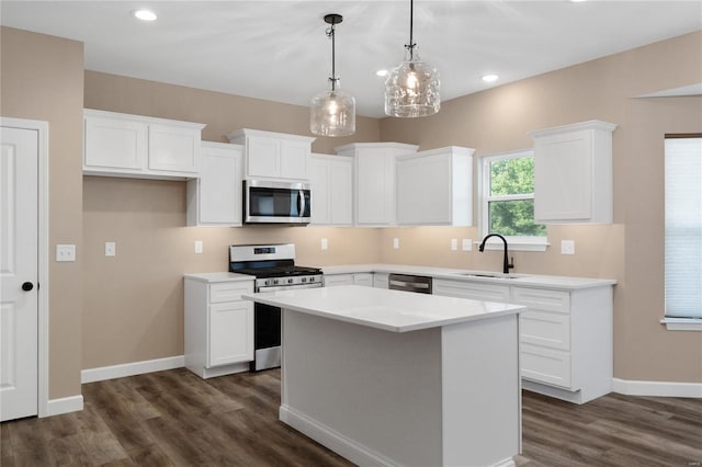 kitchen featuring sink, white cabinets, a center island, and stainless steel appliances