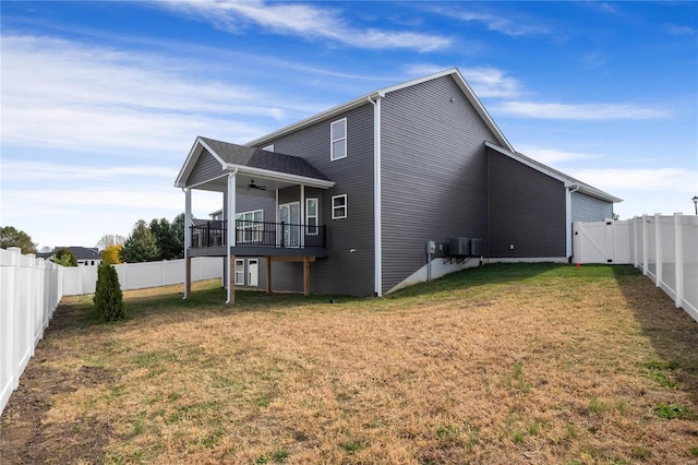 back of house with ceiling fan, a lawn, and central air condition unit