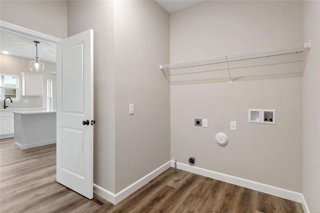 laundry room featuring hookup for a gas dryer, wood-type flooring, sink, hookup for a washing machine, and electric dryer hookup