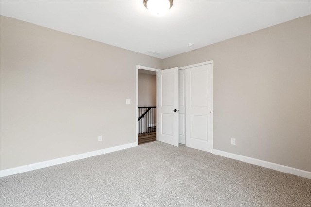 unfurnished bedroom featuring a closet and carpet floors