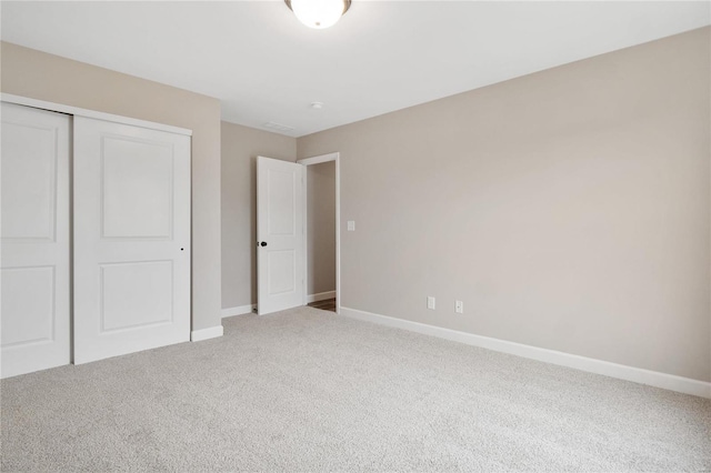 unfurnished bedroom with carpet and a closet