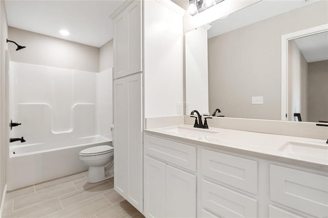 full bathroom featuring shower / bathing tub combination, vanity, and toilet