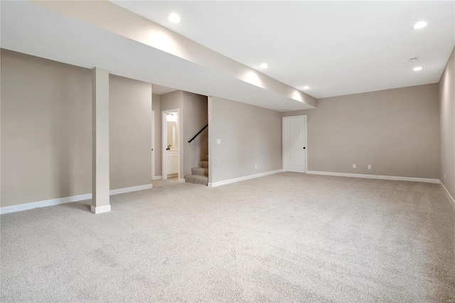 basement featuring light carpet