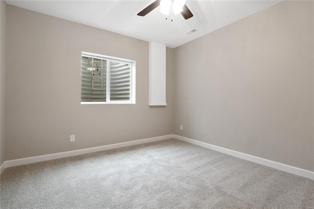 empty room featuring ceiling fan and carpet