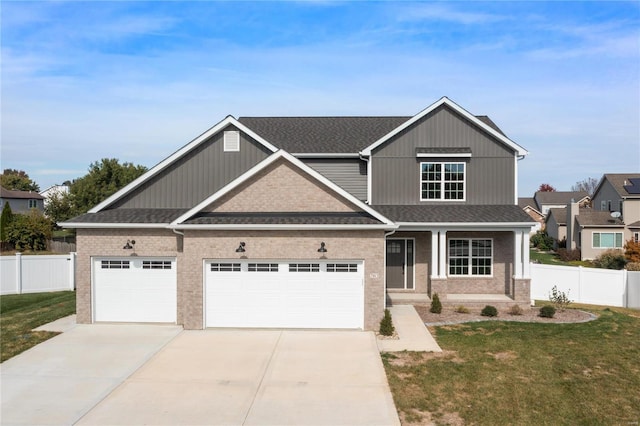 craftsman inspired home featuring a front yard and a garage